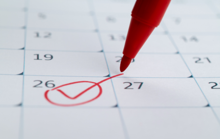 Red marker checking off date on calendar