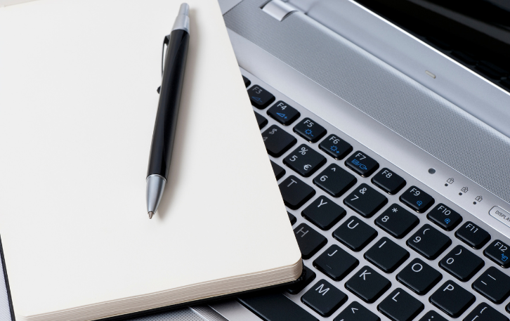 blank notebook with laptop and pen